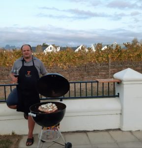 Rikus Neethling of Bizoe Wines while cooking on Weber
